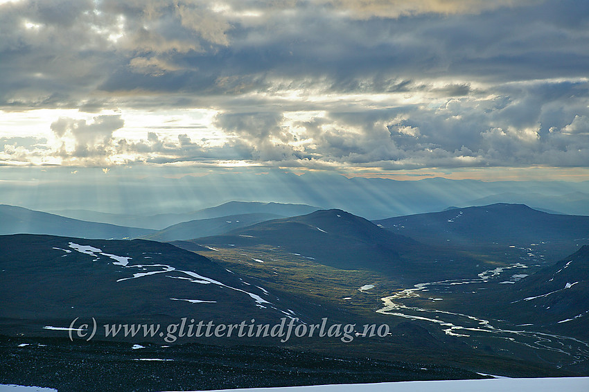 Utsikt øst til nordøstover fra Glittertinden mot Veodalen en tidlig sommermorgen. I det fjeren kan konturene av Rondane anes.