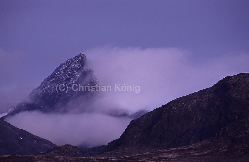 On an autumn morning mist is lifting from Koldedalen wrapping Falketinden like wads of smoke.