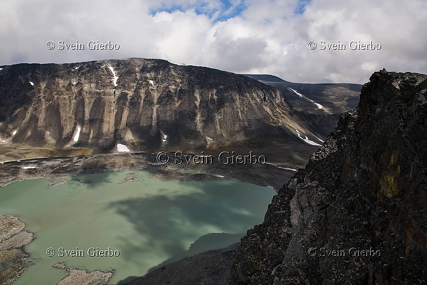 Grotbreahesten (right), Søre Trollsteinhøe and Trollsteintjønne lake below. Jotunheimen National Park. Norway.