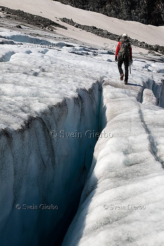 Hiker on Storjuvbrean glacier. Jotunheimen National Park. Norway.