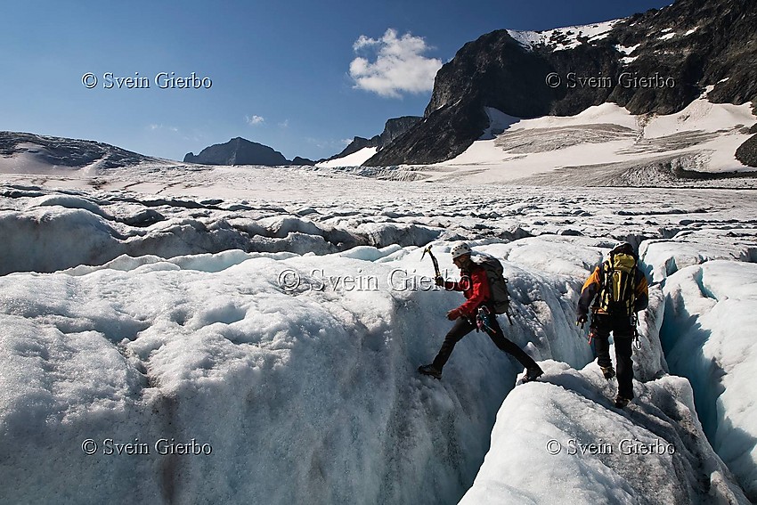 Hikers on Storjuvbrean glacier. Jotunheimen National Park. Norway.