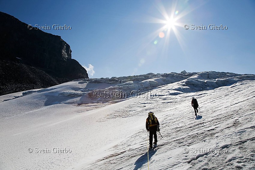 Hikers on Storjuvbrean glacier. Jotunheimen National Park. Norway.