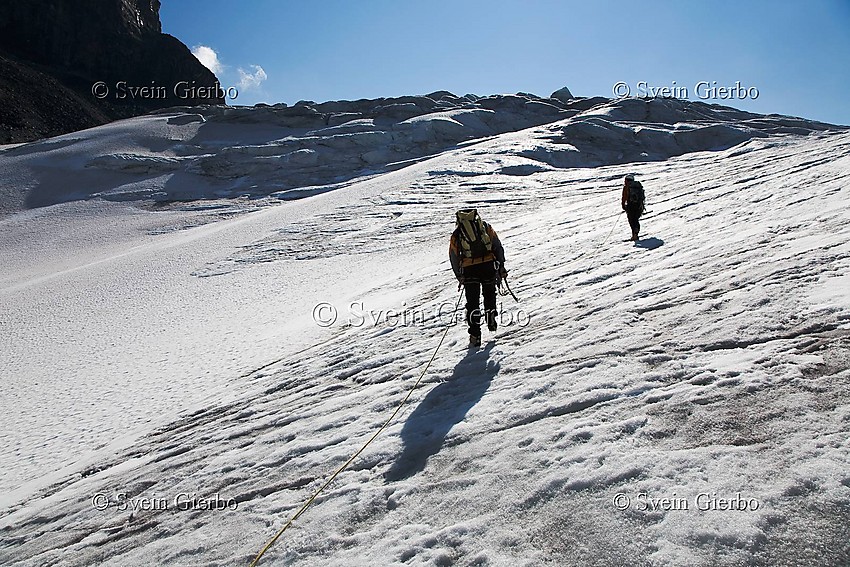 Hikers on Storjuvbrean glacier. Jotunheimen National Park. Norway.