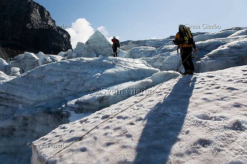 Hikers on Storjuvbrean glacier. Jotunheimen National Park. Norway.