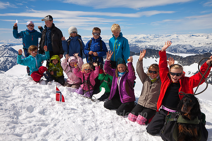 Valdres Tur- og Fjellsportlag på toppen av Galdhøpiggen, 14 barn fra 4 år og oppover. Ikke verst det!