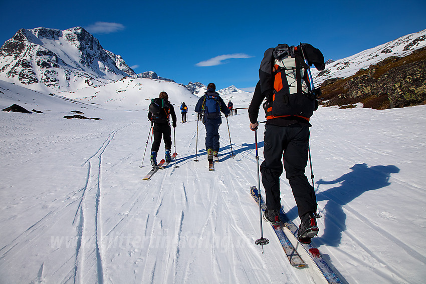 Skiløpere på vei innover Leirungsdalen mot turens mål, Munken (2105 moh), som ses til venstre i bildet.