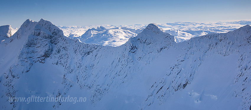 Vi flyr langs nordsiden av Styggedalsryggen i ca. 2300 meters høyde. Fra venstre ser vi Styggedalstindane (2387 moh). Deretter Sentraltind (2348 moh) sentralt og Vetle Skagastølstinden (2340 moh) helt til høyre.