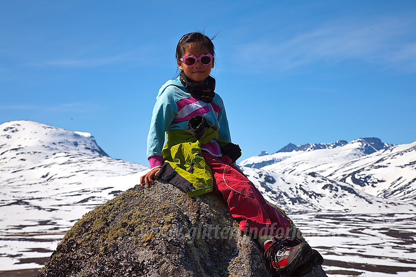 Pause på stein under en tur til Søre Brurskardknappen. Gjendealpene i bakgrunnen.