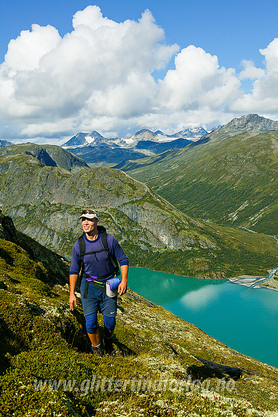 På vei opp Memuruhåmåren påsørsiden av Gjende. I bakgrunnen Sjugurdtinden på Memurutunga. Man ser godt hvor stien fra Memurubu vestover mot Gjendebu går.