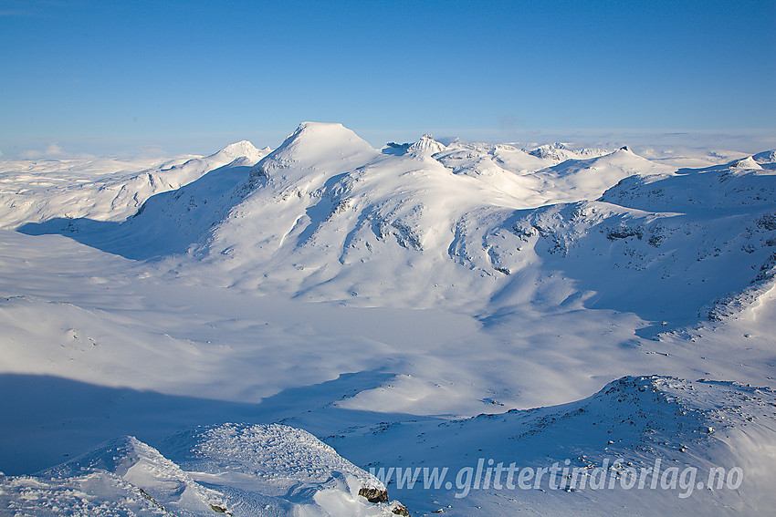 Utsikt fra nordvestryggen på Mjølkedalstinden mot bl.a Rauddalen, det snødekte Rauddalsvatnet og Store Rauddalstinden (2157 moh).